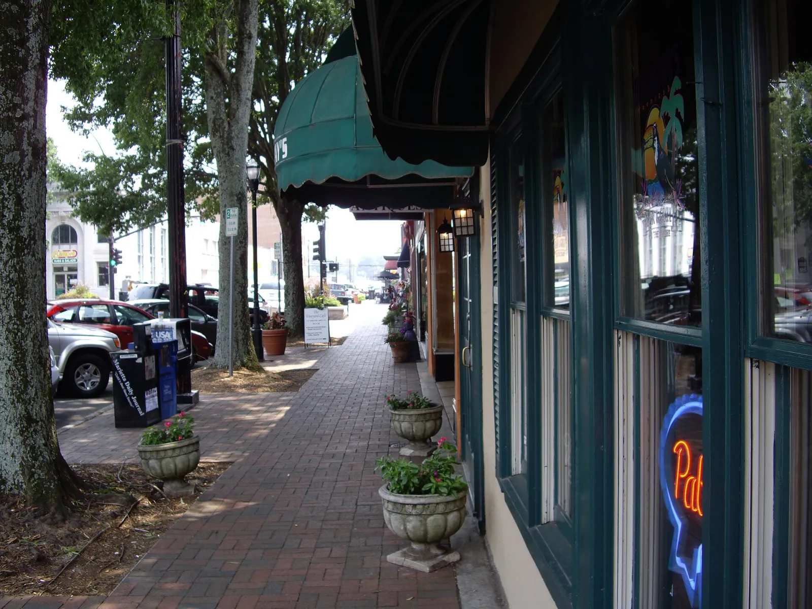 Awnings and storefront restaurants along the brick sidewalk on Marietta Square