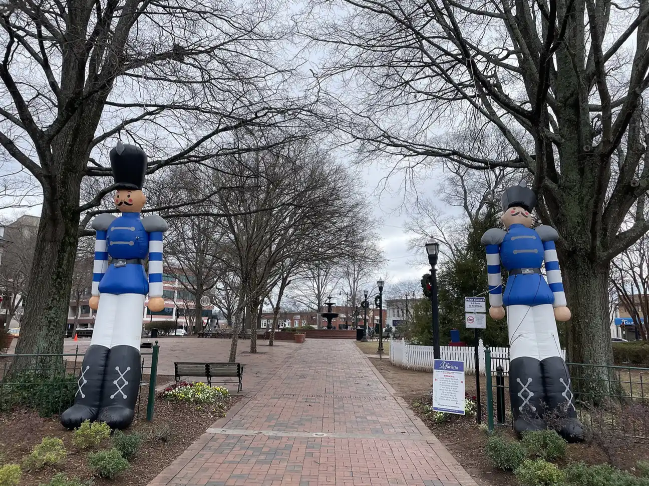 Glover Park on Marietta Square decorated for the holidays, with giant nutcracker figures along the brick path