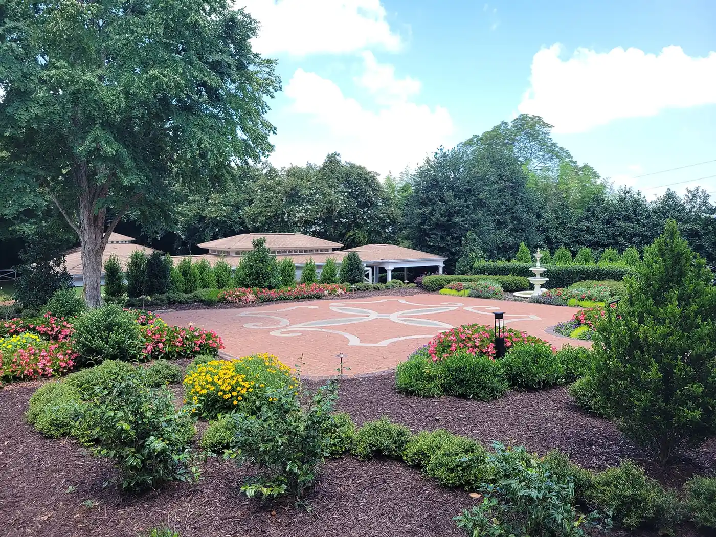 The brick courtyard, fountain and spring flower beds of the gardens at Brumby Hall in Marietta