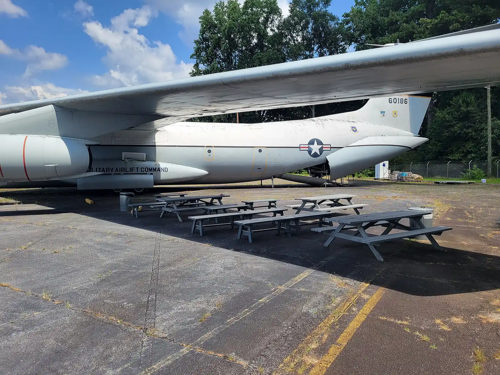 Picnic tables in the shade of a Lockheed StarLifter's wing at the Aviation History and Technology Center in Marietta