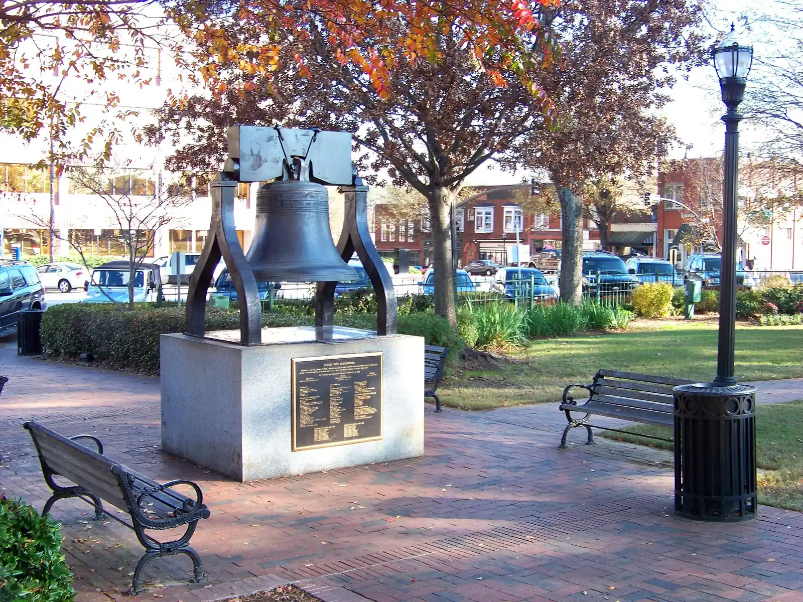 The Liberty Bell replica among fall trees in Glover Park on Marietta Square