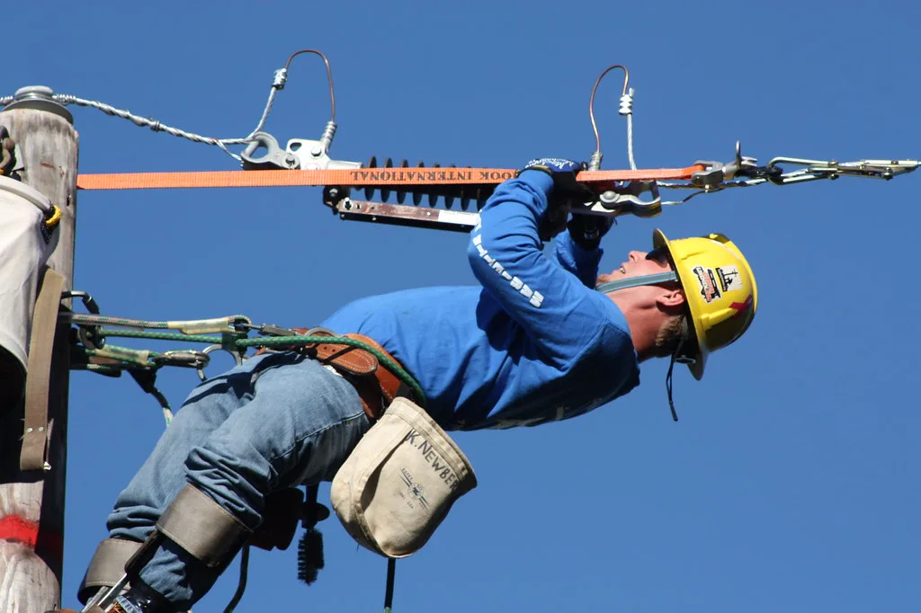 A Marietta Power and Water lineman works at the top of a utility pole during a state linemen's competition. The photo does not show the new switches.