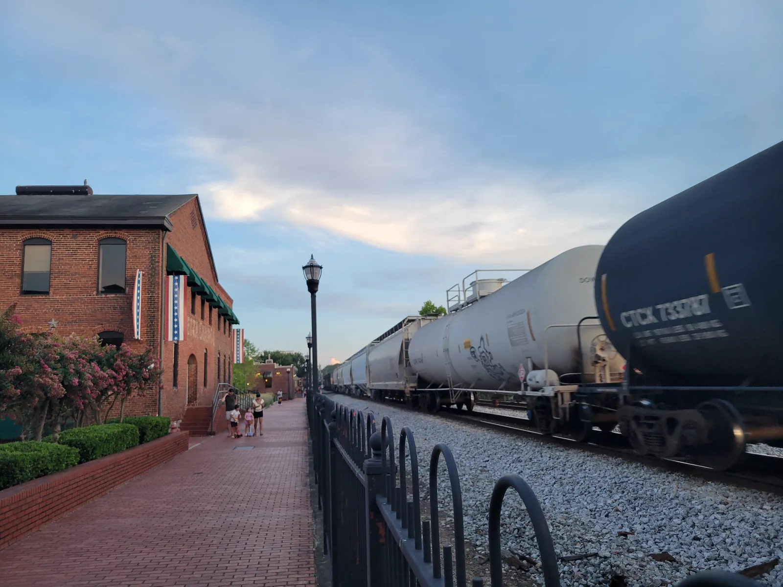 A freight train passes the Mountain to River Trail beside the railroad near downtown Marietta