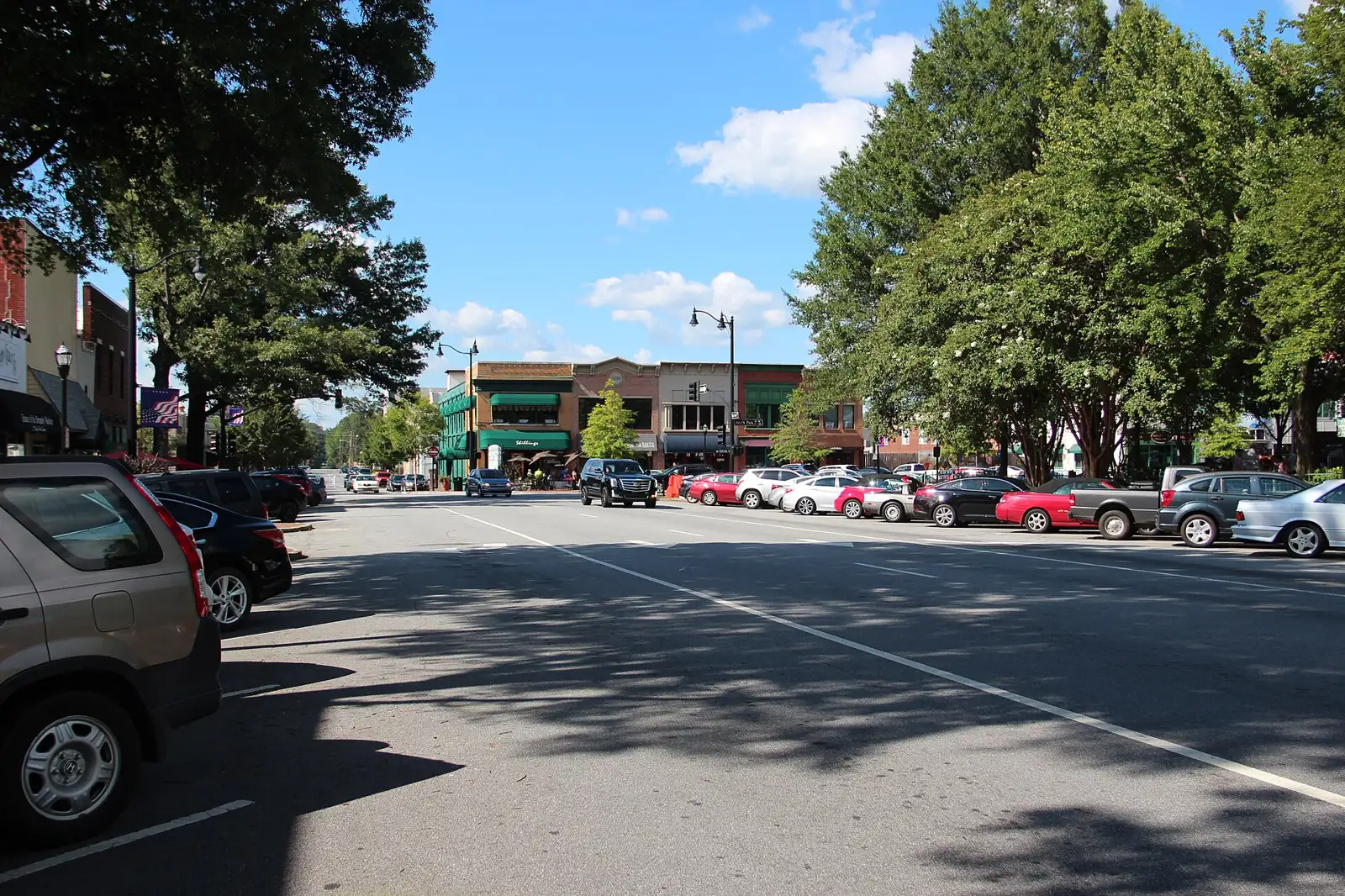 Shops and parked cars along a street in downtown Marietta