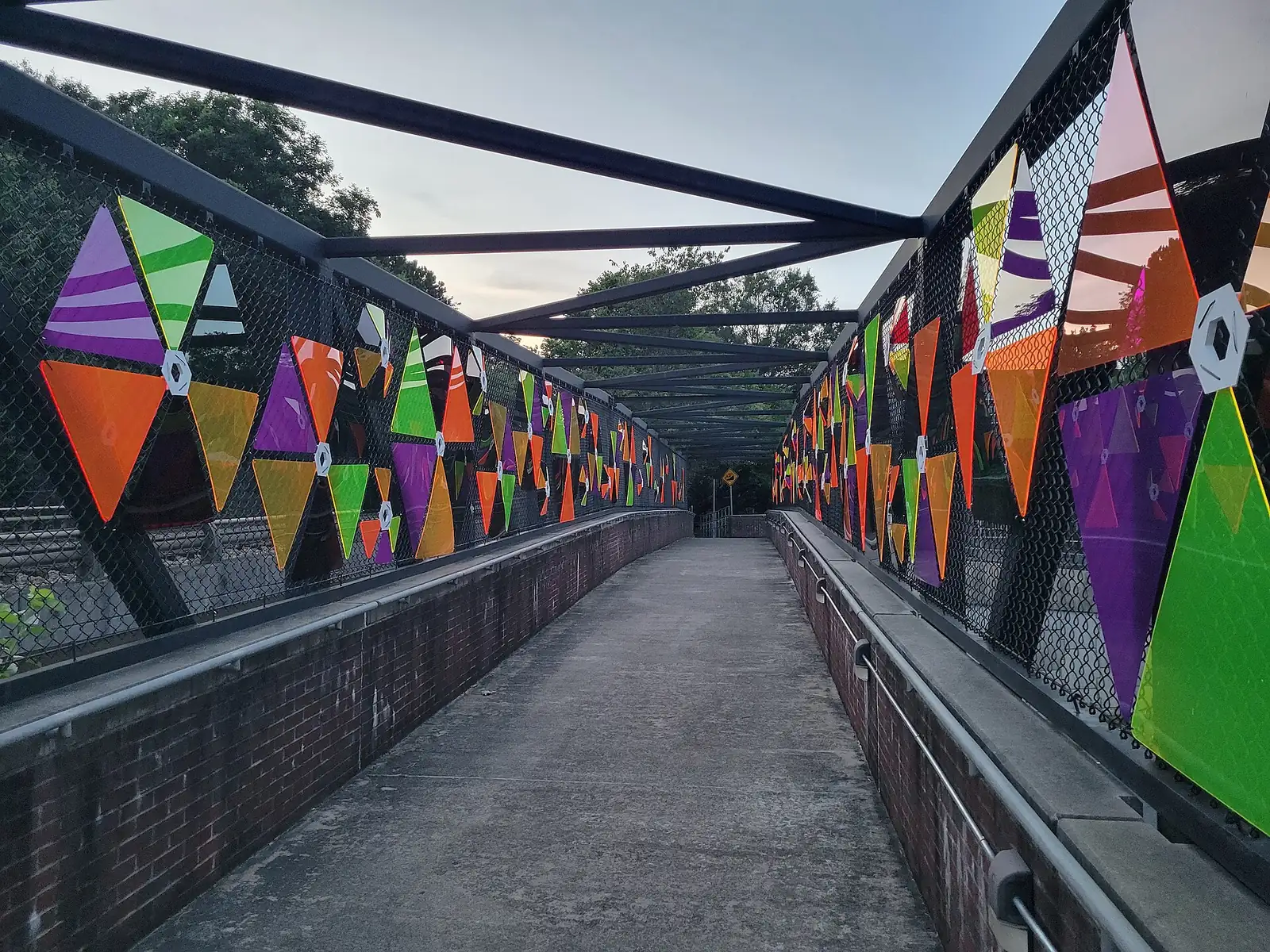 Colorful panels line the Mountain to River Trail bridge over North Marietta Parkway