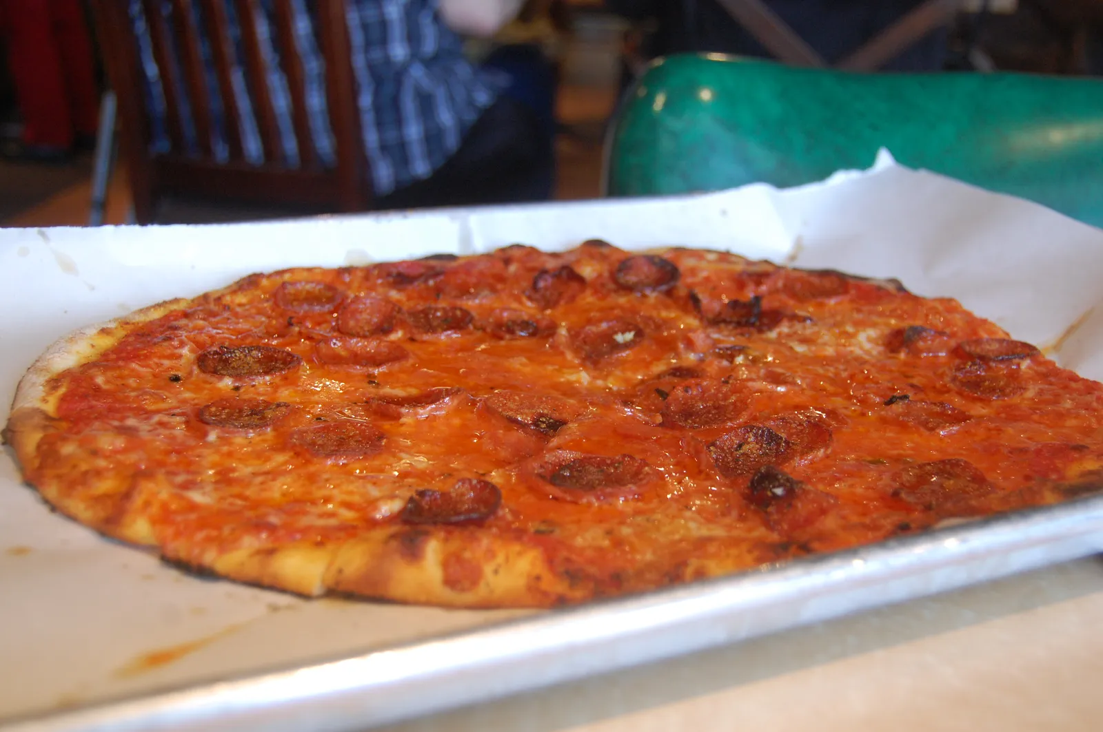 A thin-crust pepperoni pizza on a metal tray. The photo was not taken at a Marietta restaurant.