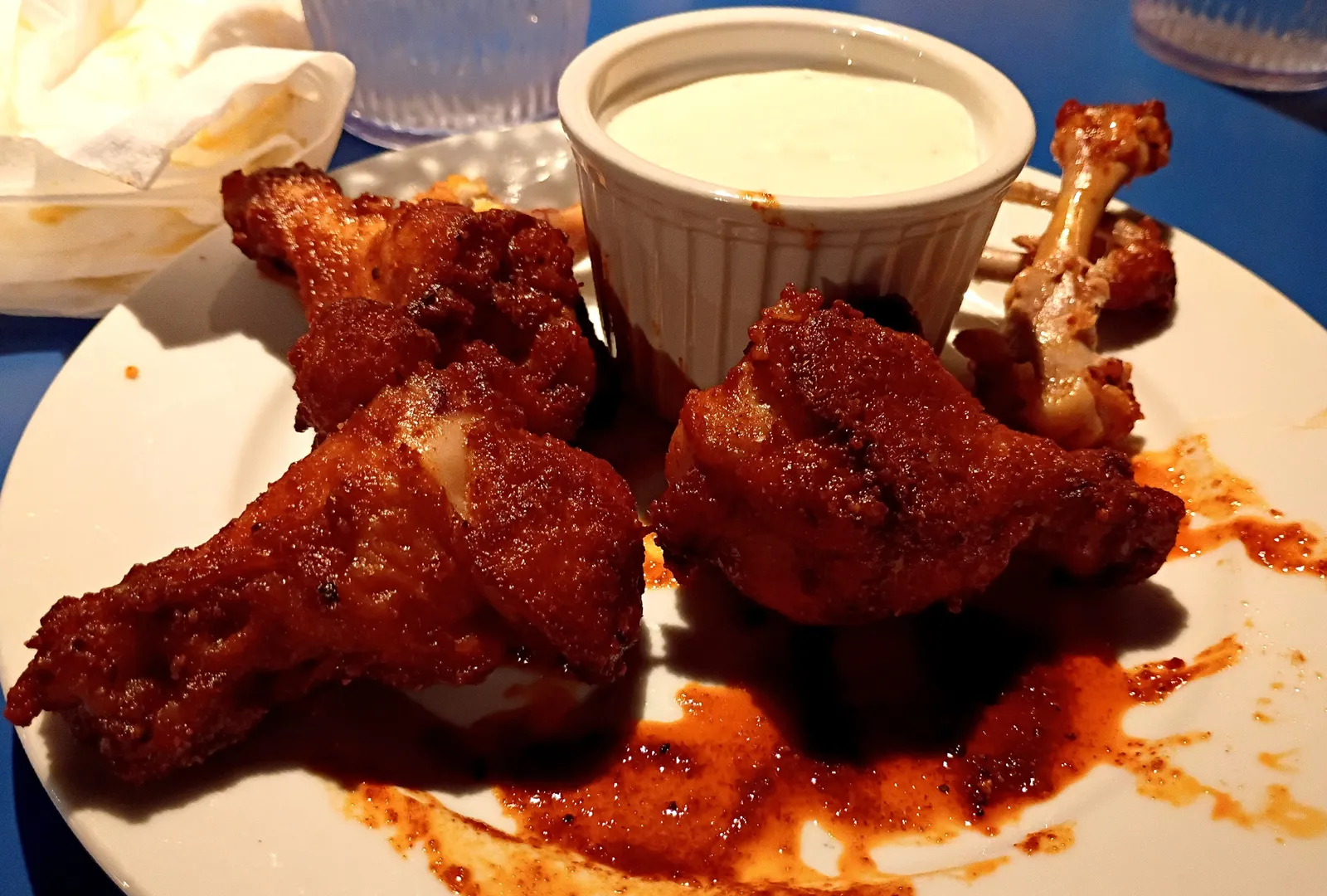 A plate of sauced chicken wings with a dipping cup. The photo was not taken at a Marietta restaurant.